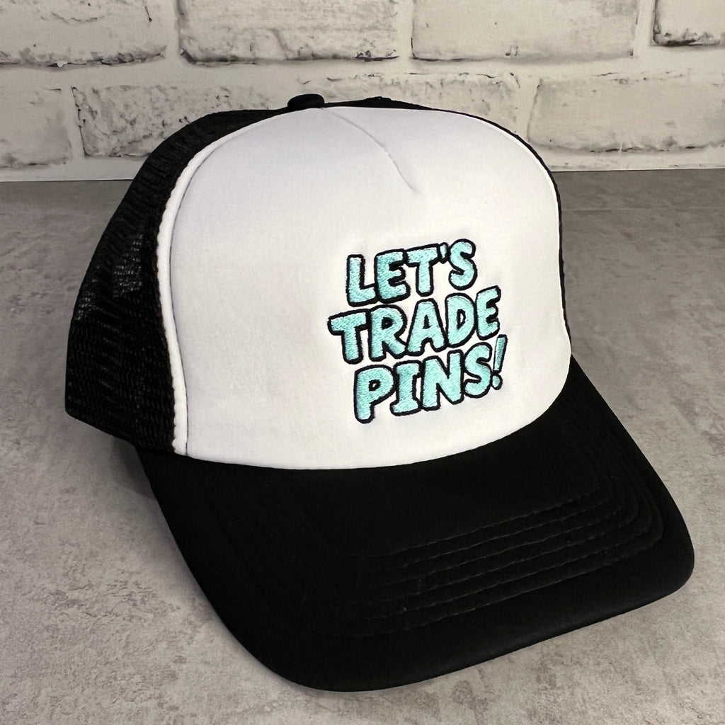 Black and white trucker hat with 'Let's Trade Pins!' text
