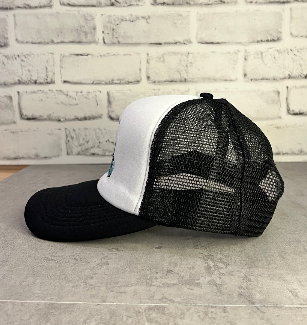 Black and white trucker hat with Let's Trade Pins text